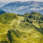 Aerial view of mountains in Flumserberg, Flums, Switzerland with trails and lake in the background